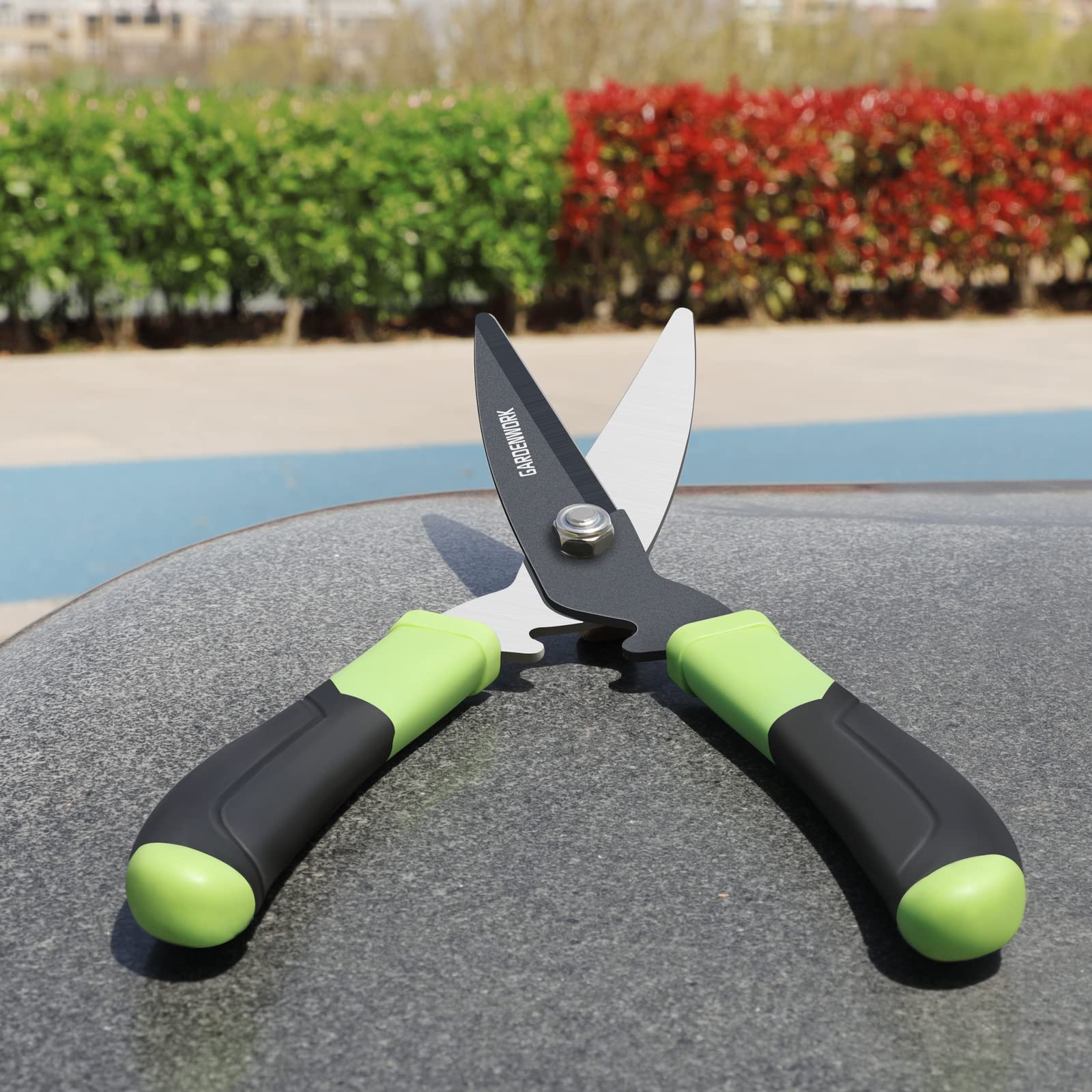 GardenWORK 16-inch hedge shears shown in use for shaping hedges and shrubs.