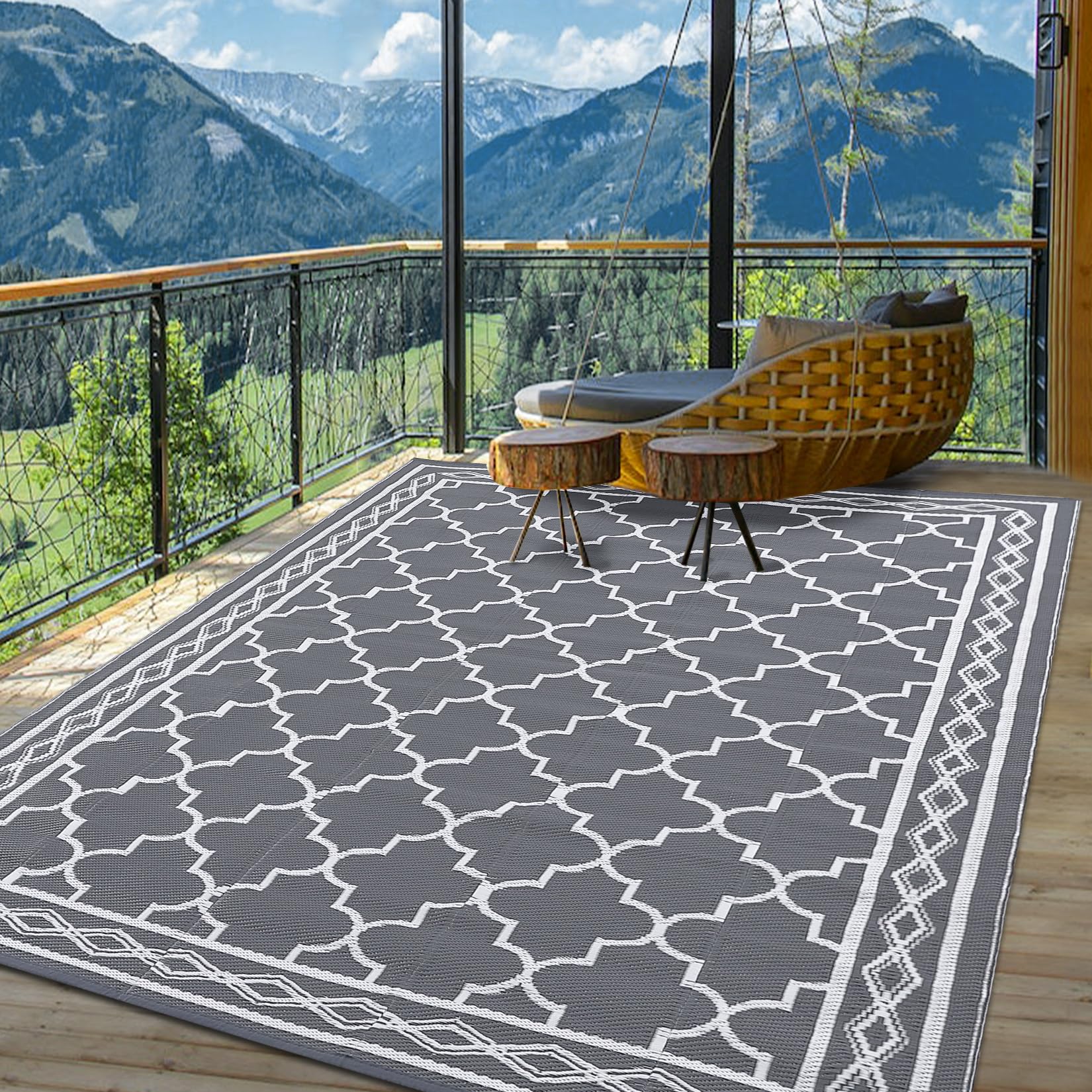 Garvee rug secured with corner loops and stakes on an RV campground