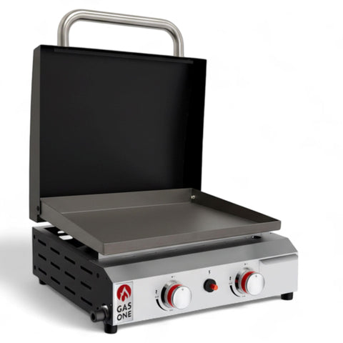 Gas One flat-top grill with lid for portable outdoor cooking at family gatherings.