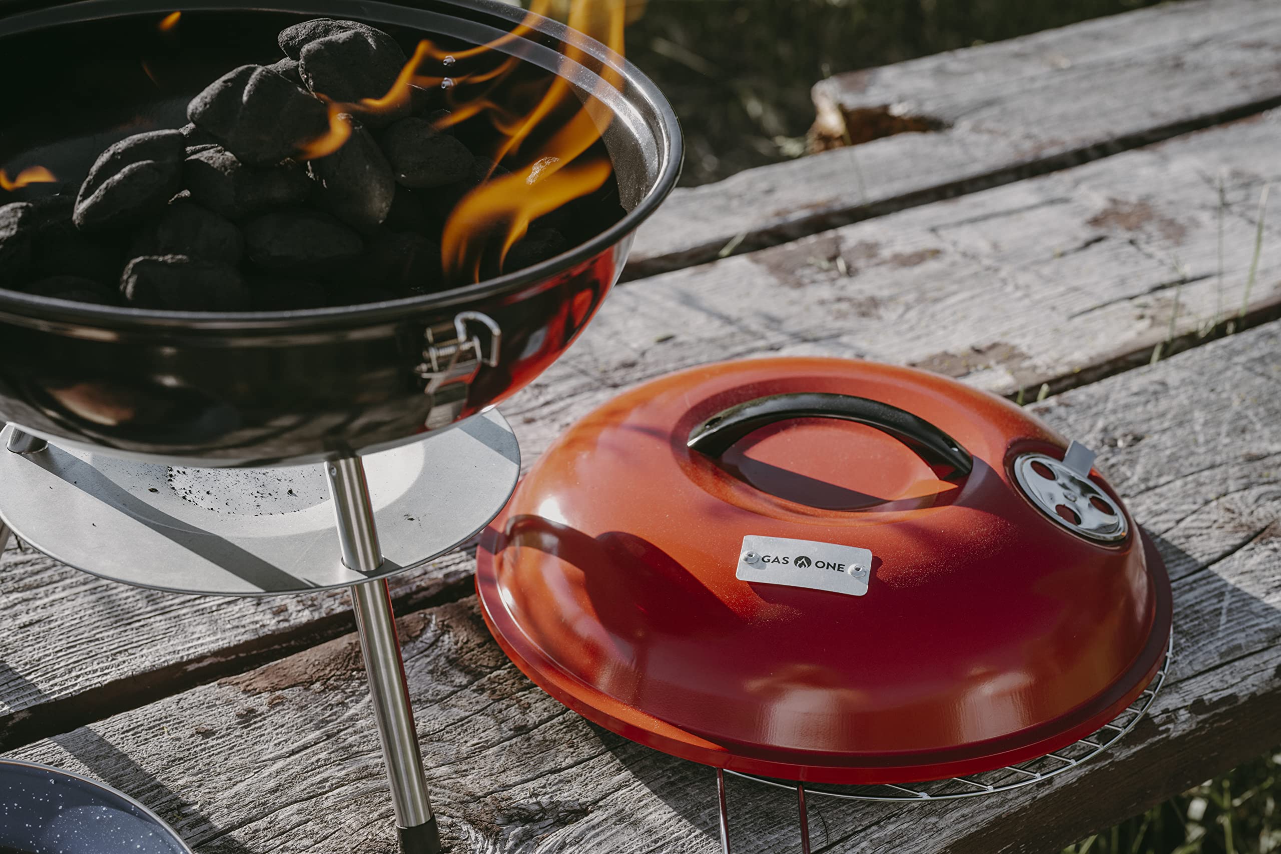 Gas One outdoor camping scene highlights versatile charcoal grilling anywhere.