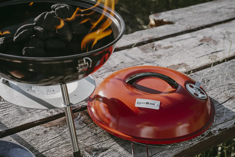 Gas One outdoor camping scene highlights versatile charcoal grilling anywhere.