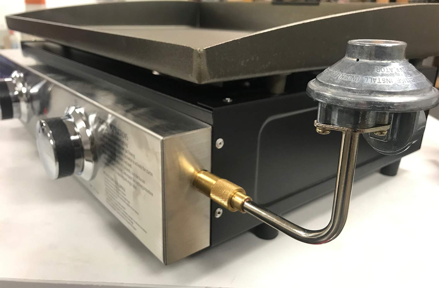GasSaf griddle regulator connected to a 1-pound propane tank for portable grilling.