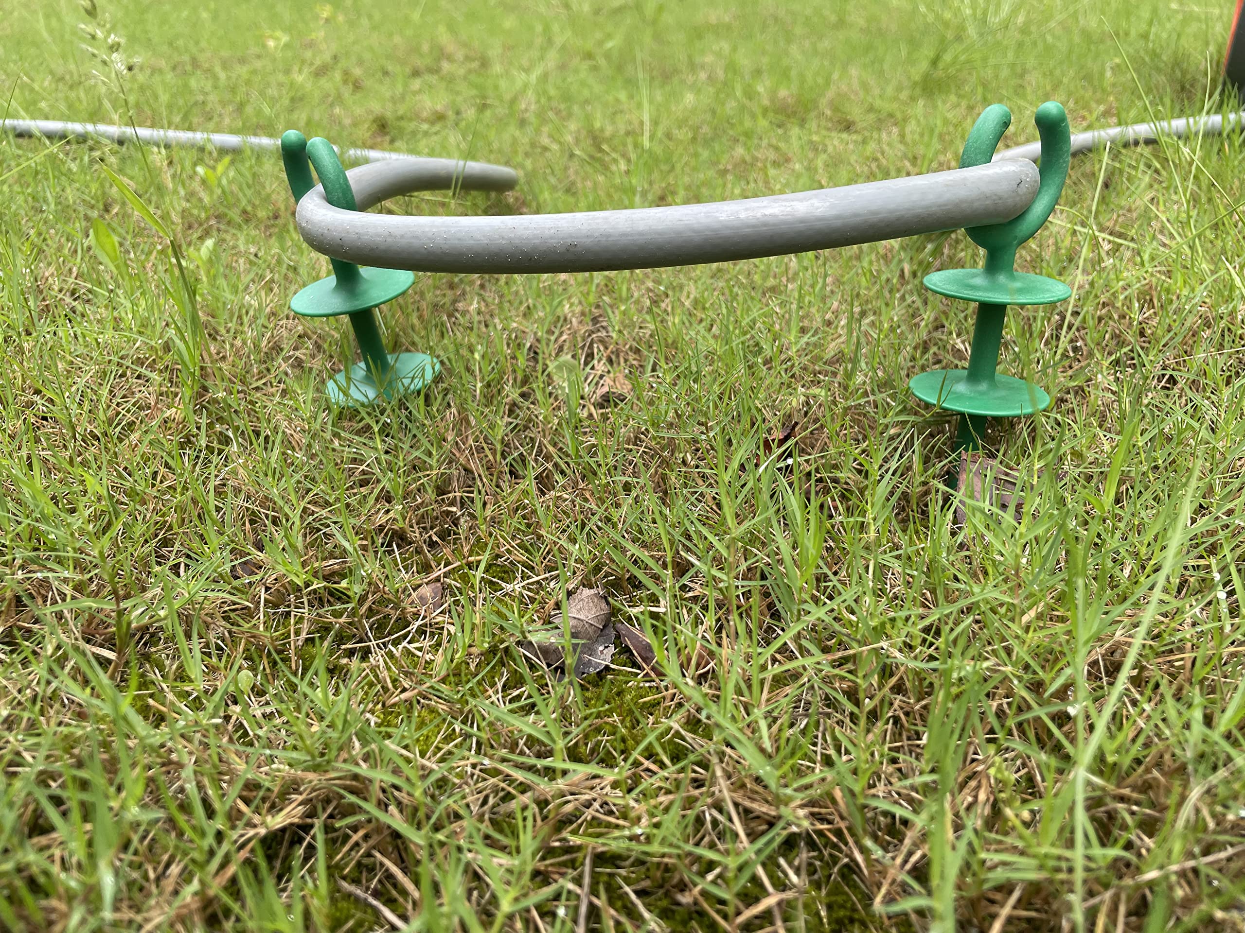 Generic garden hose guide holder nails outdoor-use weather-ready design.