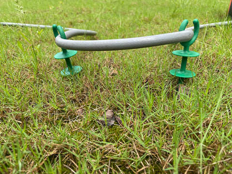 Generic garden hose guide holder nails outdoor-use weather-ready design.