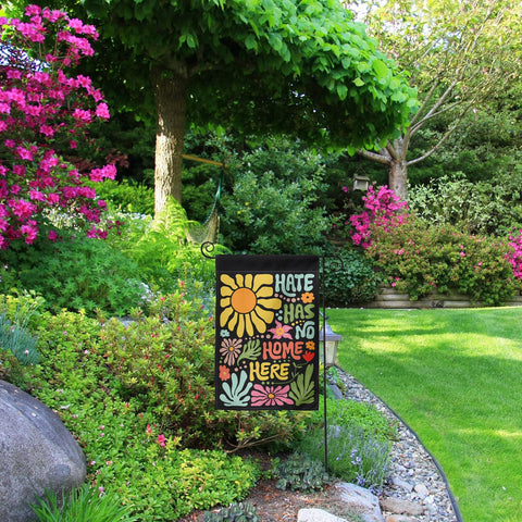 Generic Hate Has No Home Here flag used as yard decoration to brighten outdoor space