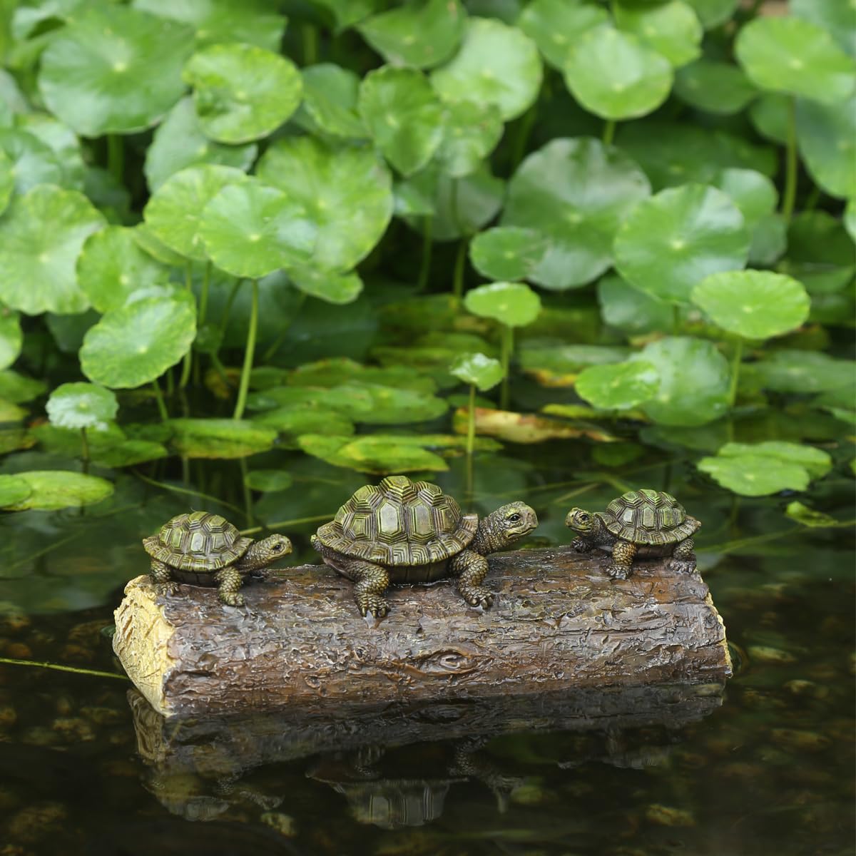 Generic Three Turtle Floating Sculptures resting on a log add natural pond charm.