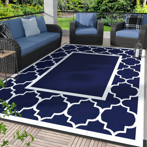 GENIMO outdoor rug blue and white foldable on a sunny patio for easy, quick-dry setup