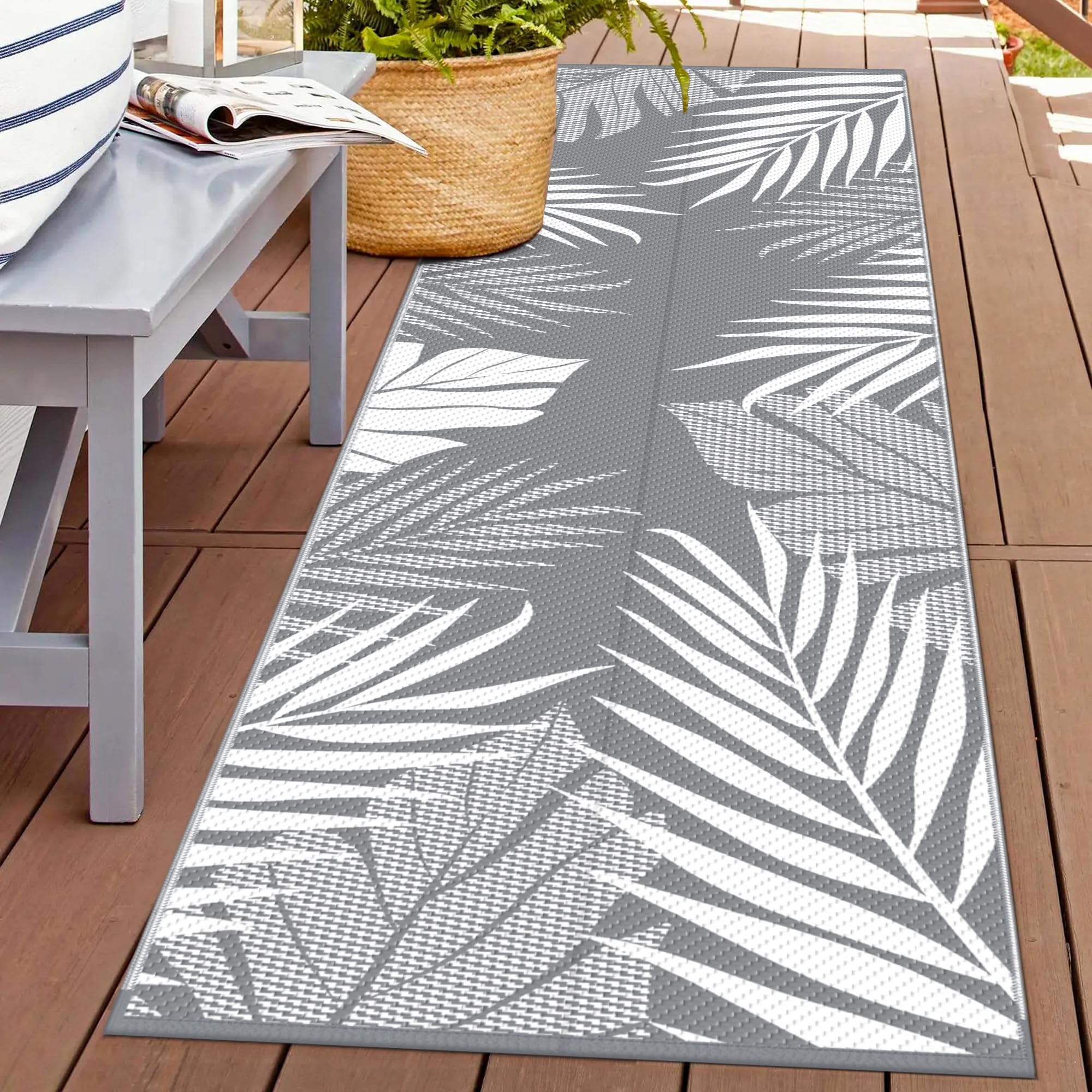 GENIMO outdoor rug with palm leaf front pattern, ideal for patio styling and durable outdoor use.
