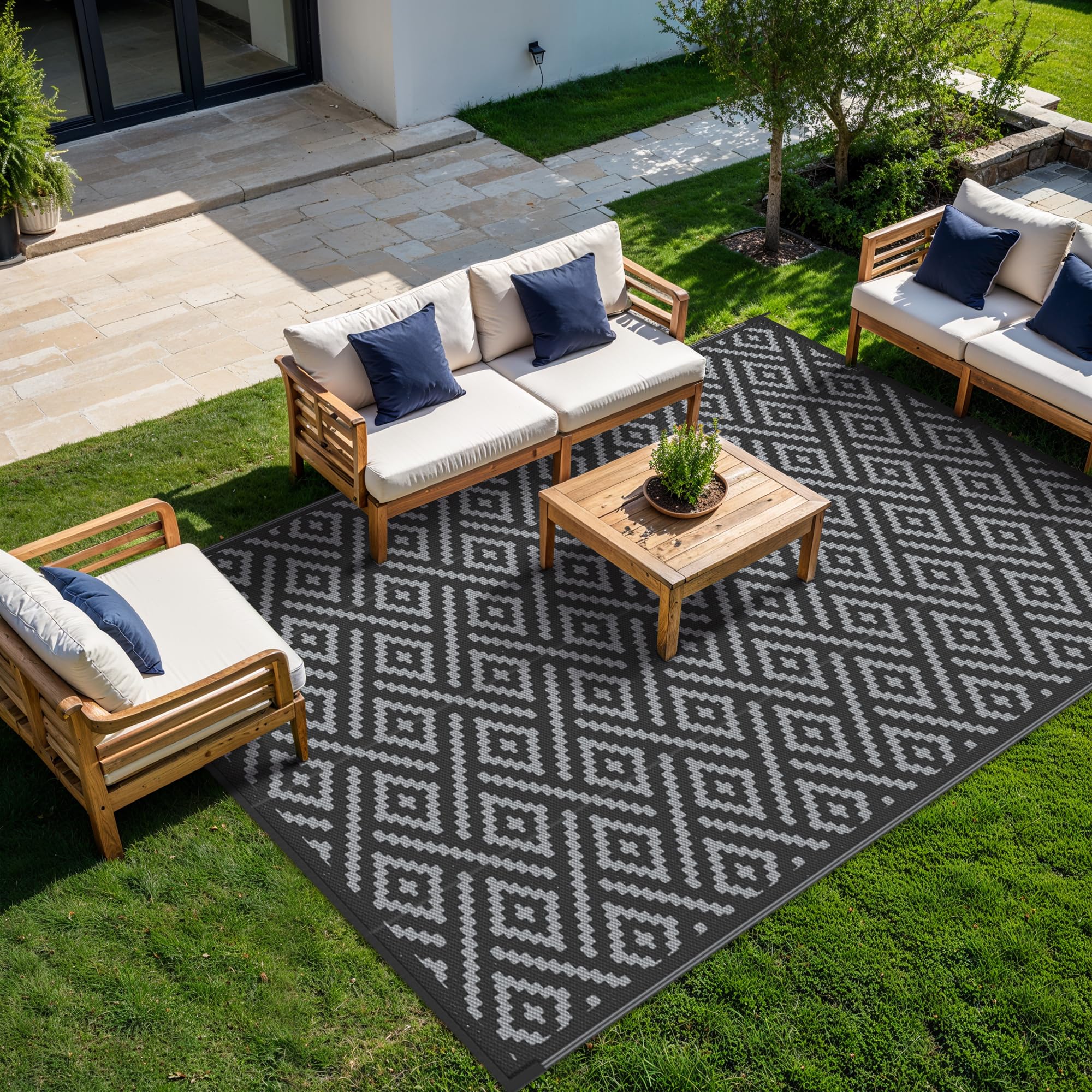 GENIMO rug with plastic straw pattern, dual-sided for versatile RV and camping use.