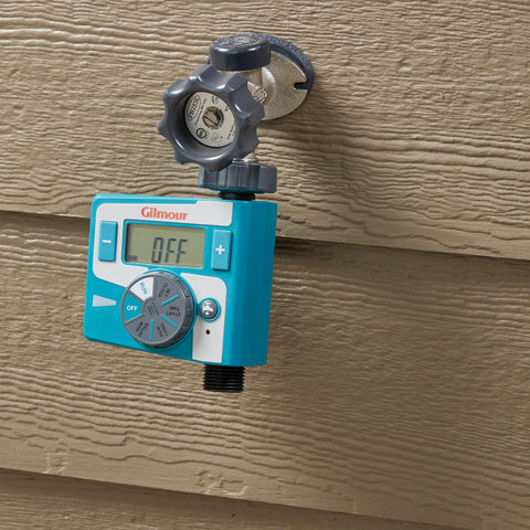 Gilmour timer in outdoor garden setup controls irrigation with ease.
