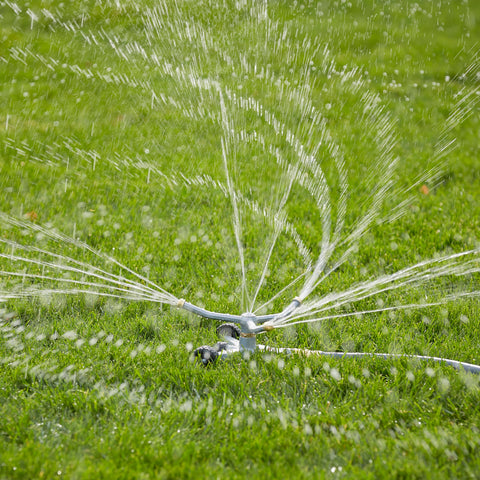 Gilmour sprinkler waters vegetables and garden beds with even distribution.