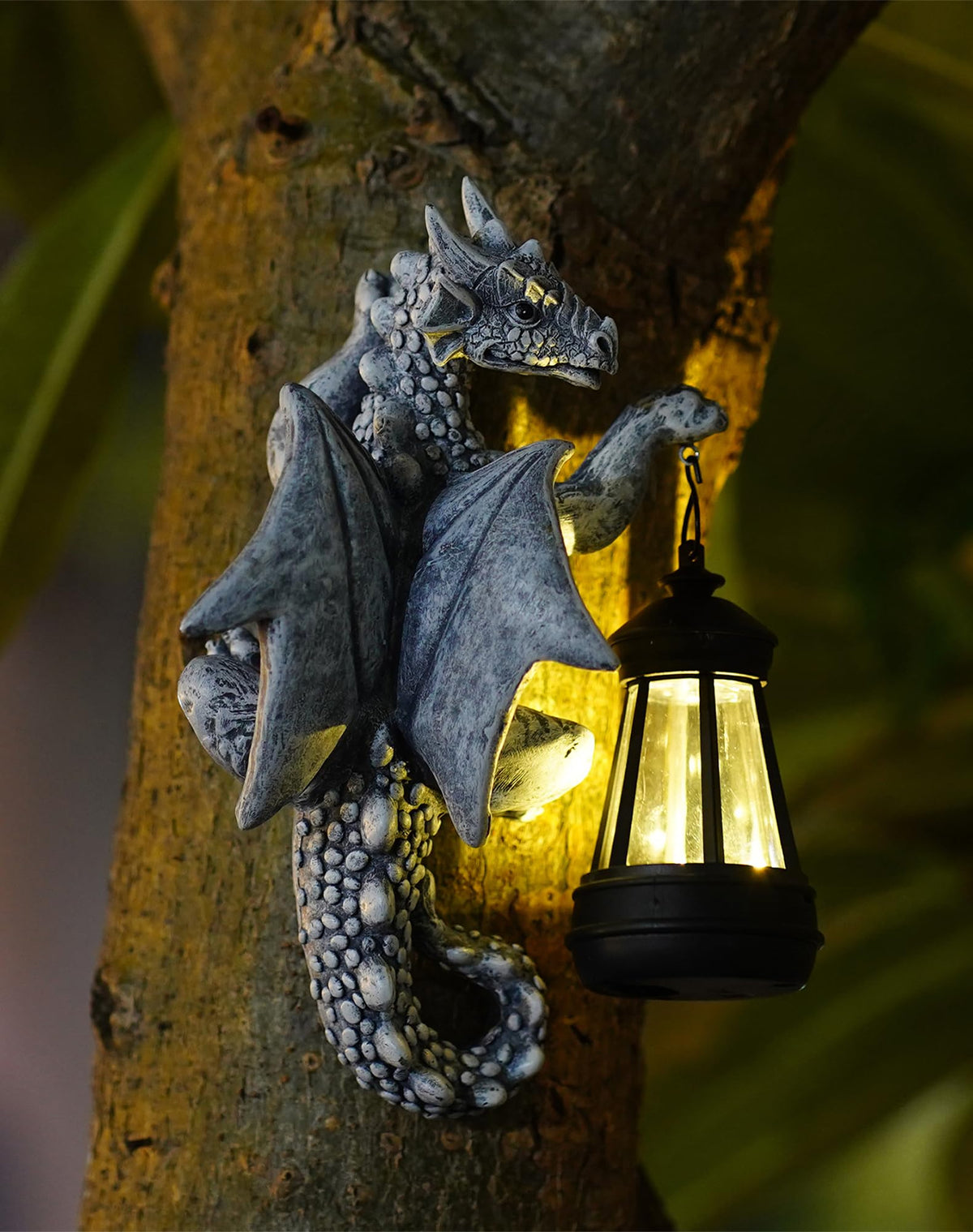 Goodeco Dragon Tree Hugger solar lantern lights the garden at night.