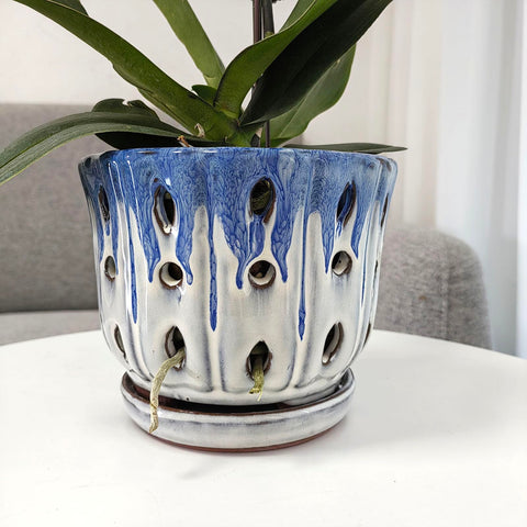 Grdthzey ceramic orchid pot shows attached saucer for easy setup.