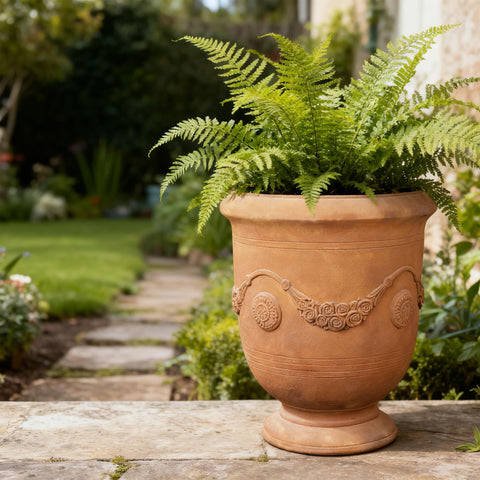 Greens Word planter-urn built-in drainage hole promotes healthy root drainage.
