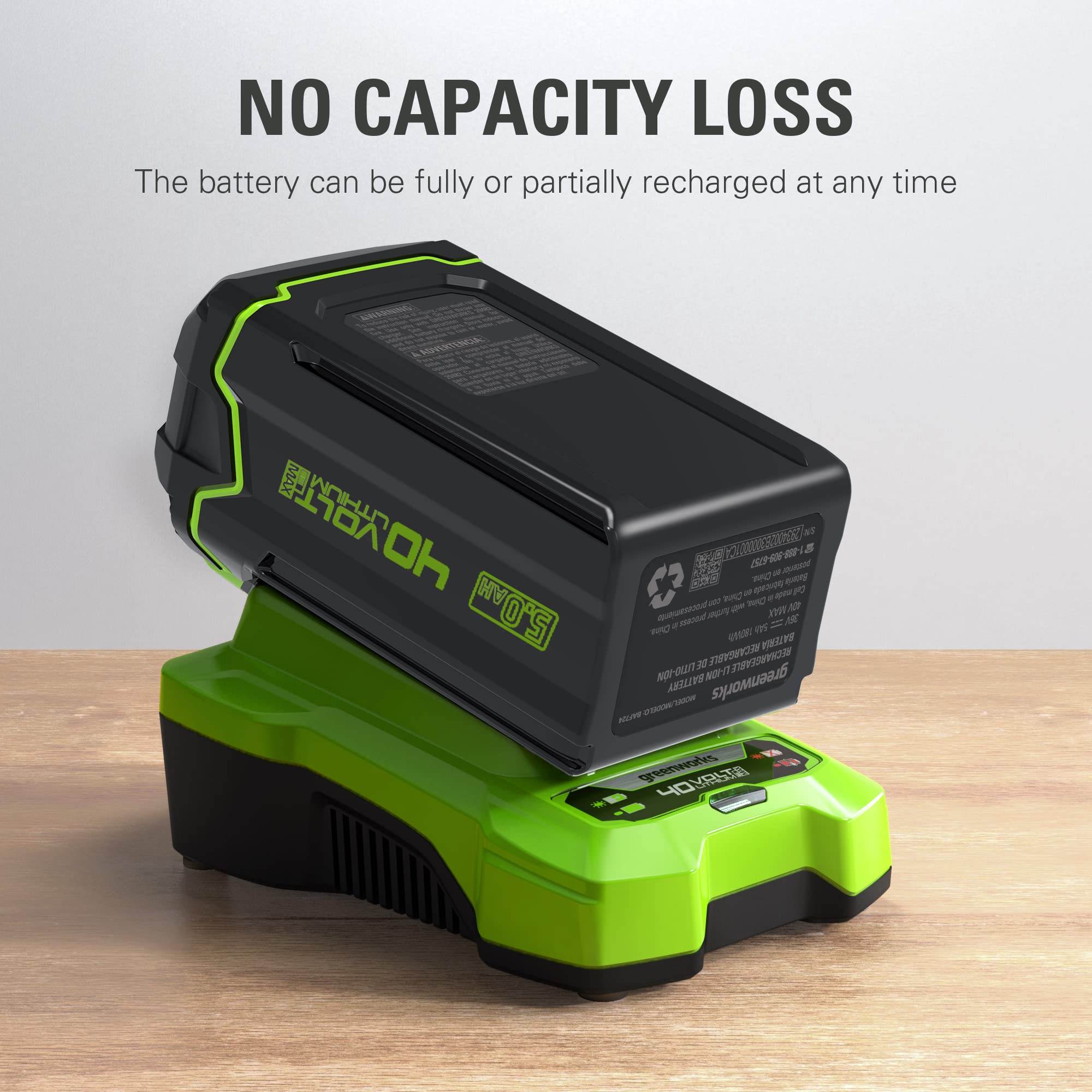 Greenworks 40V 5Ah battery being snapped in and out for hassle-free operation.