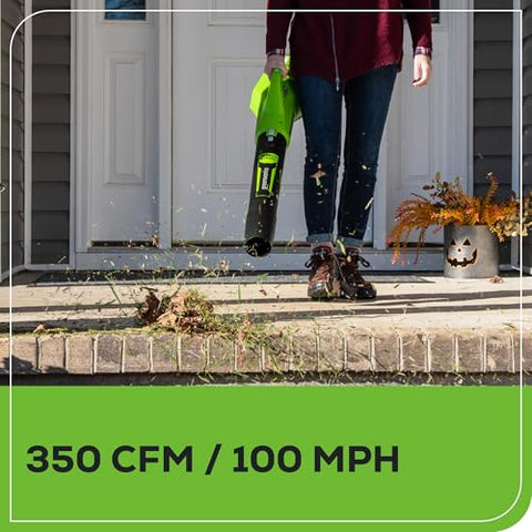 Greenworks 40V axial leaf blower powering through a deck cleanup outdoors.