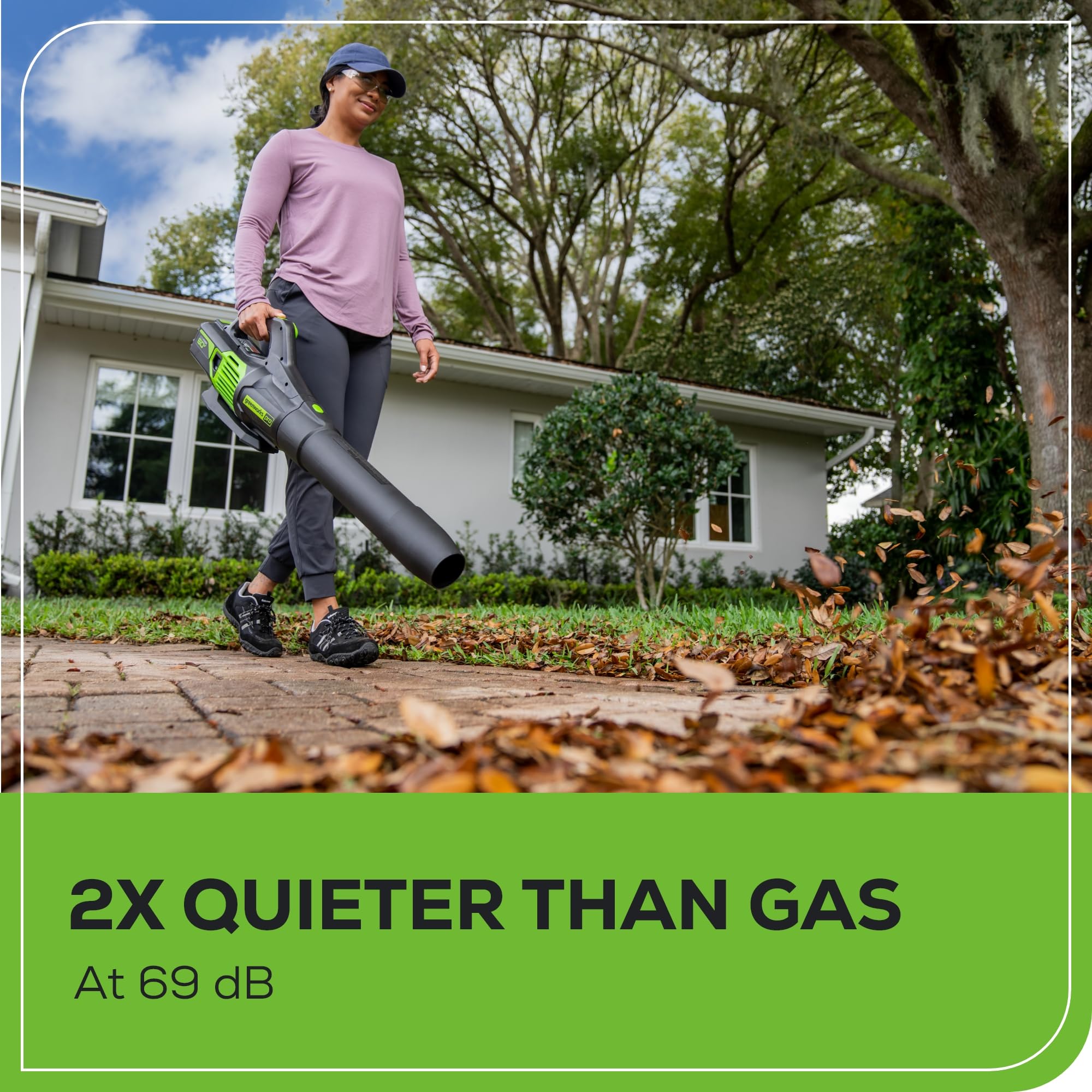 Greenworks 60V blower clearing wet leaves with steady airflow
