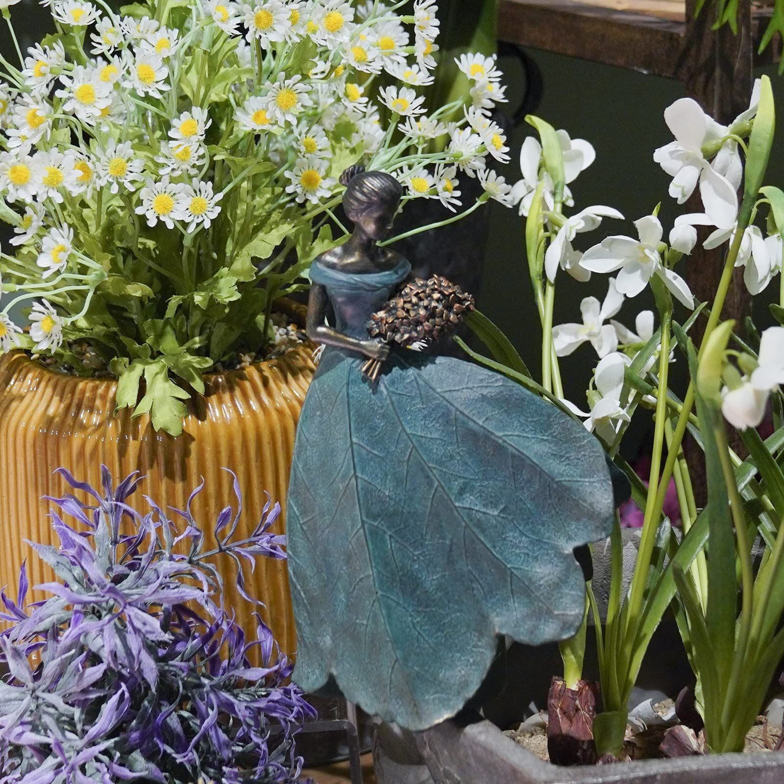 Guichifun fairy statue holding birds provides a calm focal point in garden or living area.