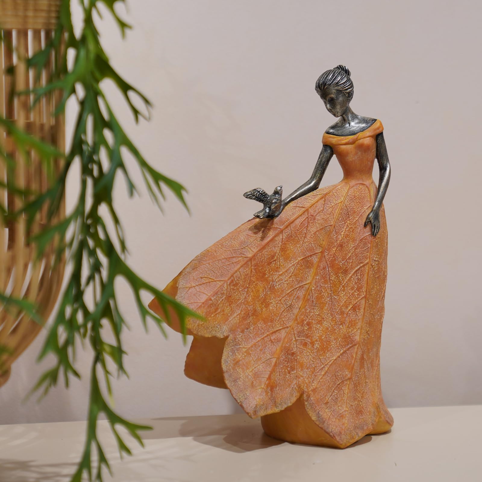 Guichifun fairy statue holding a bird brightens outdoor spaces.
