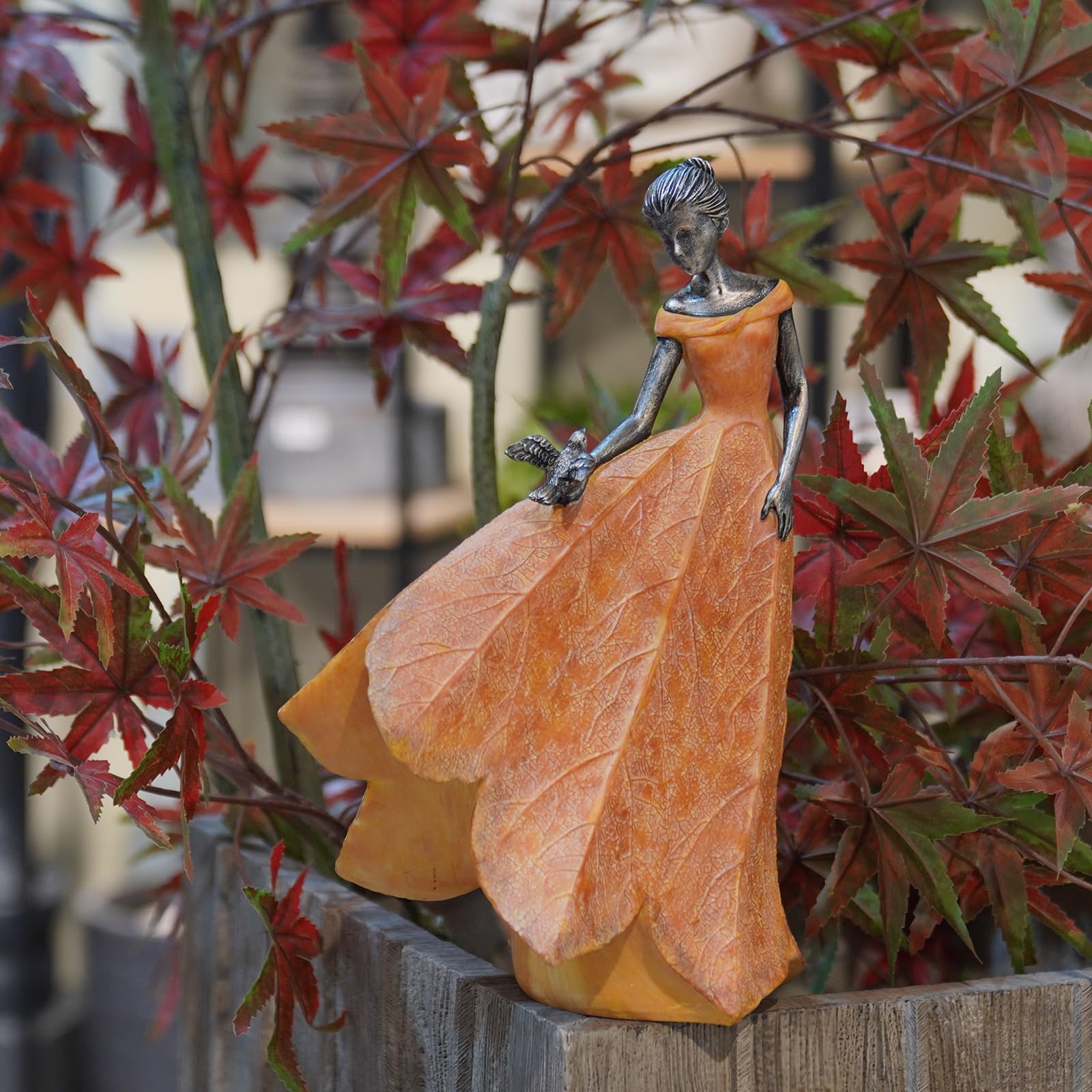 Guichifun orange leaf angel statue side view highlights leaf-textured skirt.
