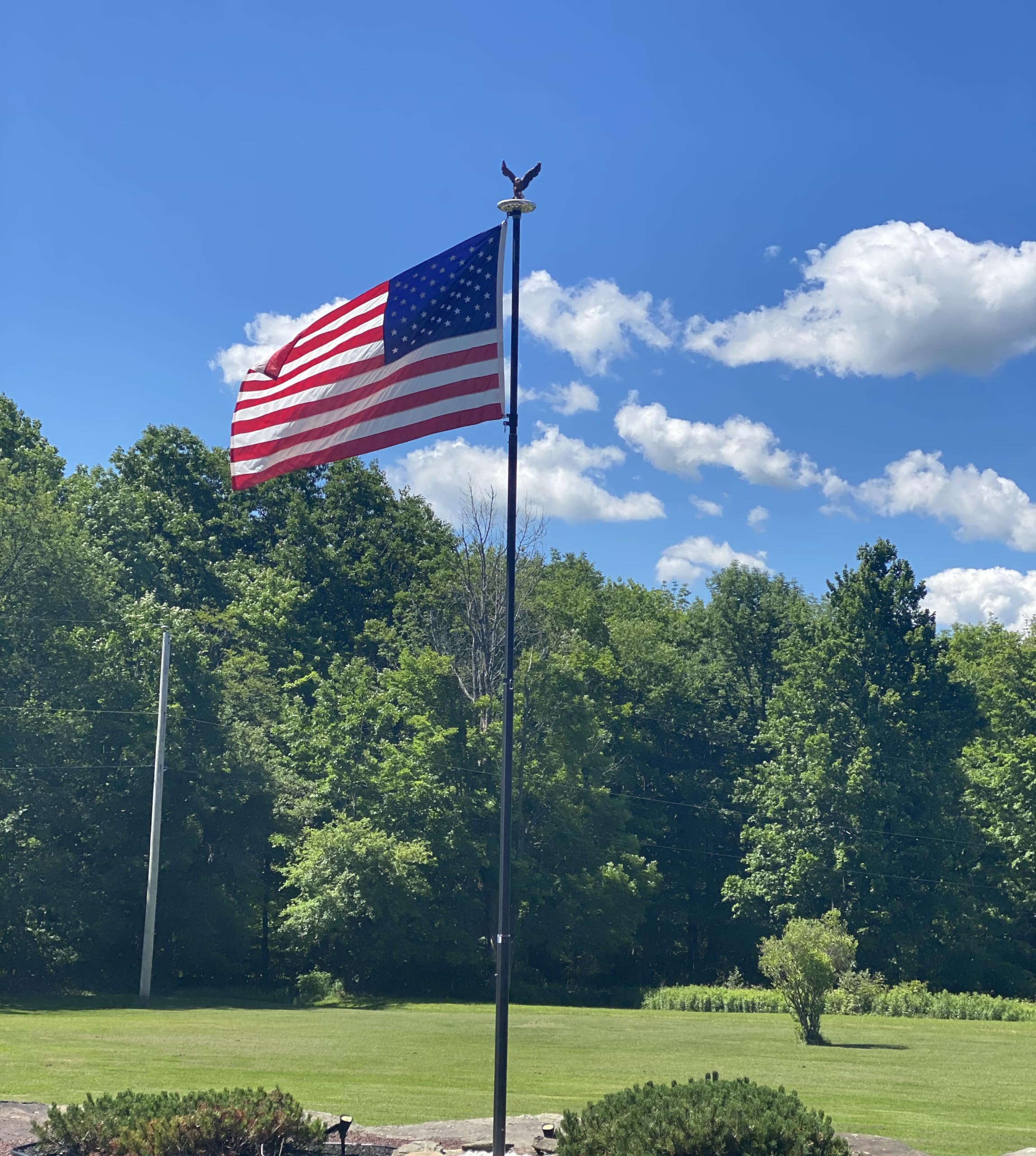 GULADUS flagpole topper outdoor-ready weatherproof resin stands up to rain and sun.
