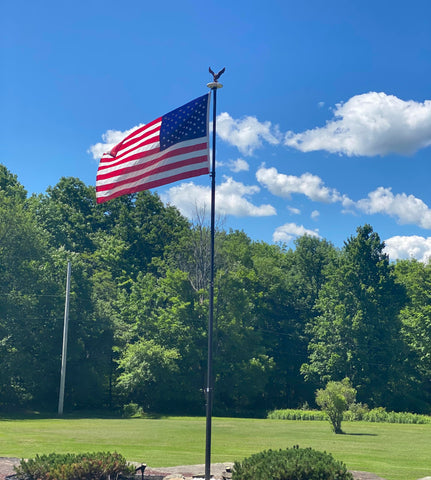 GULADUS flagpole topper outdoor-ready weatherproof resin stands up to rain and sun.
