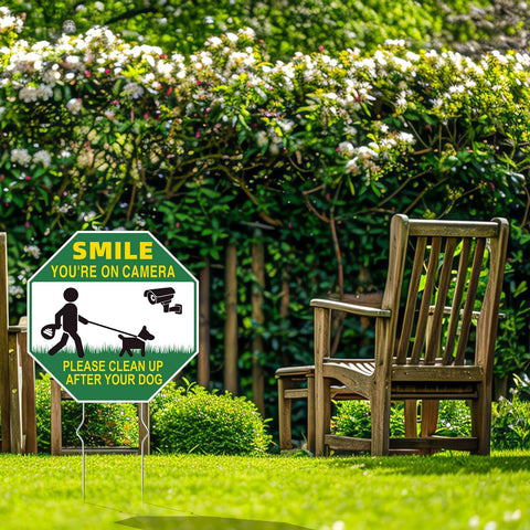 GXGGUS smile your on camera sign invites dog waste cleanup.