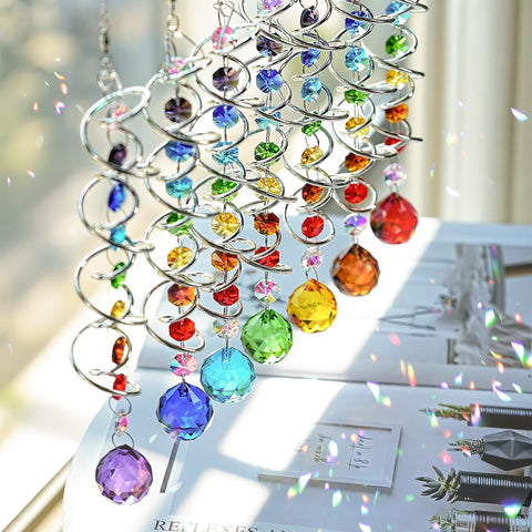 H and D Hyaline and Dora rainbow crystal prisms reflect sun across garden paths.
