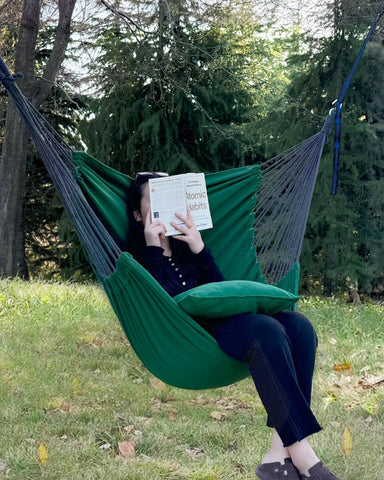 Halalona hammock chair seat cushions provide plush support during relaxed reading.