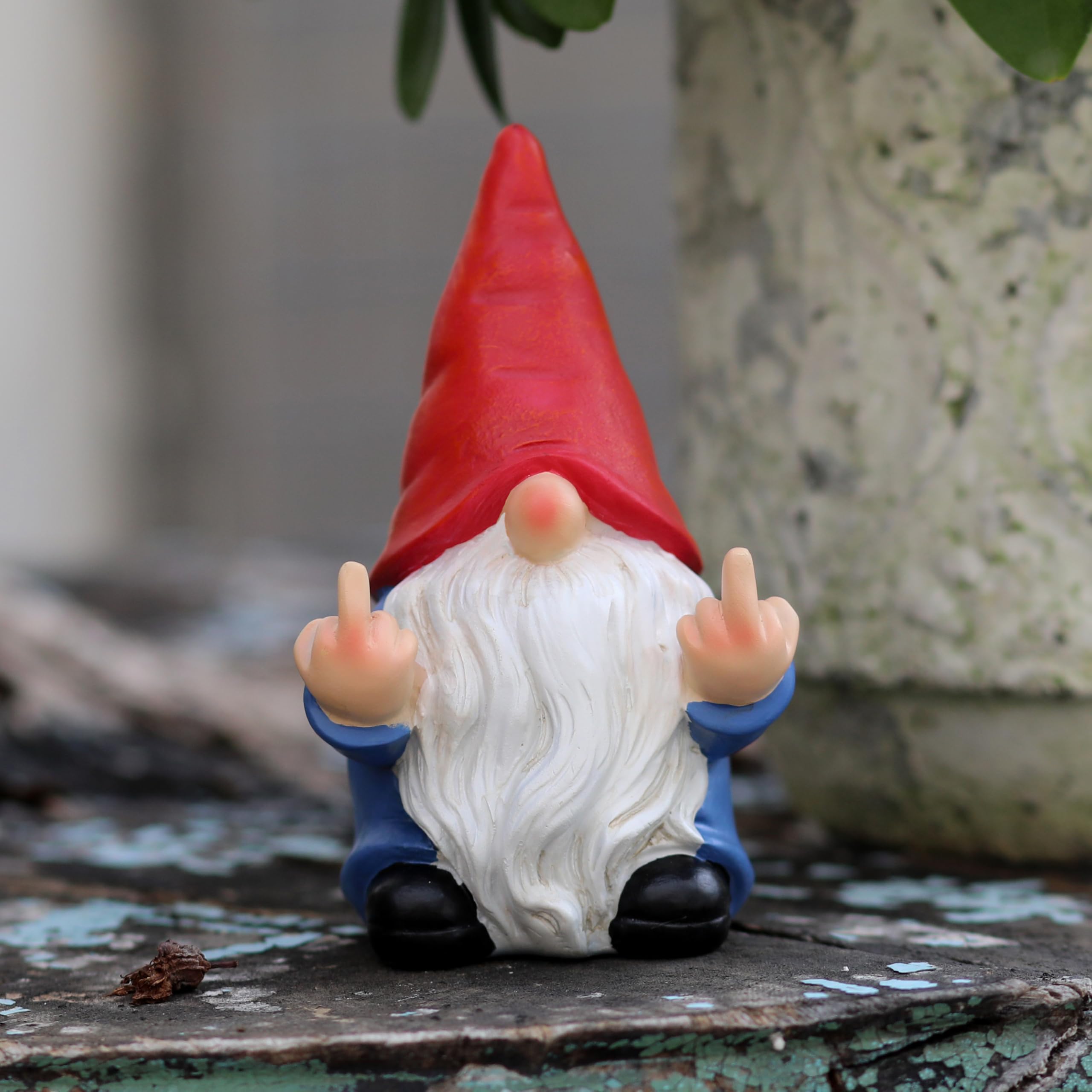Hand-painted gnome sculpture with detailed accents for a vintage vibe.
