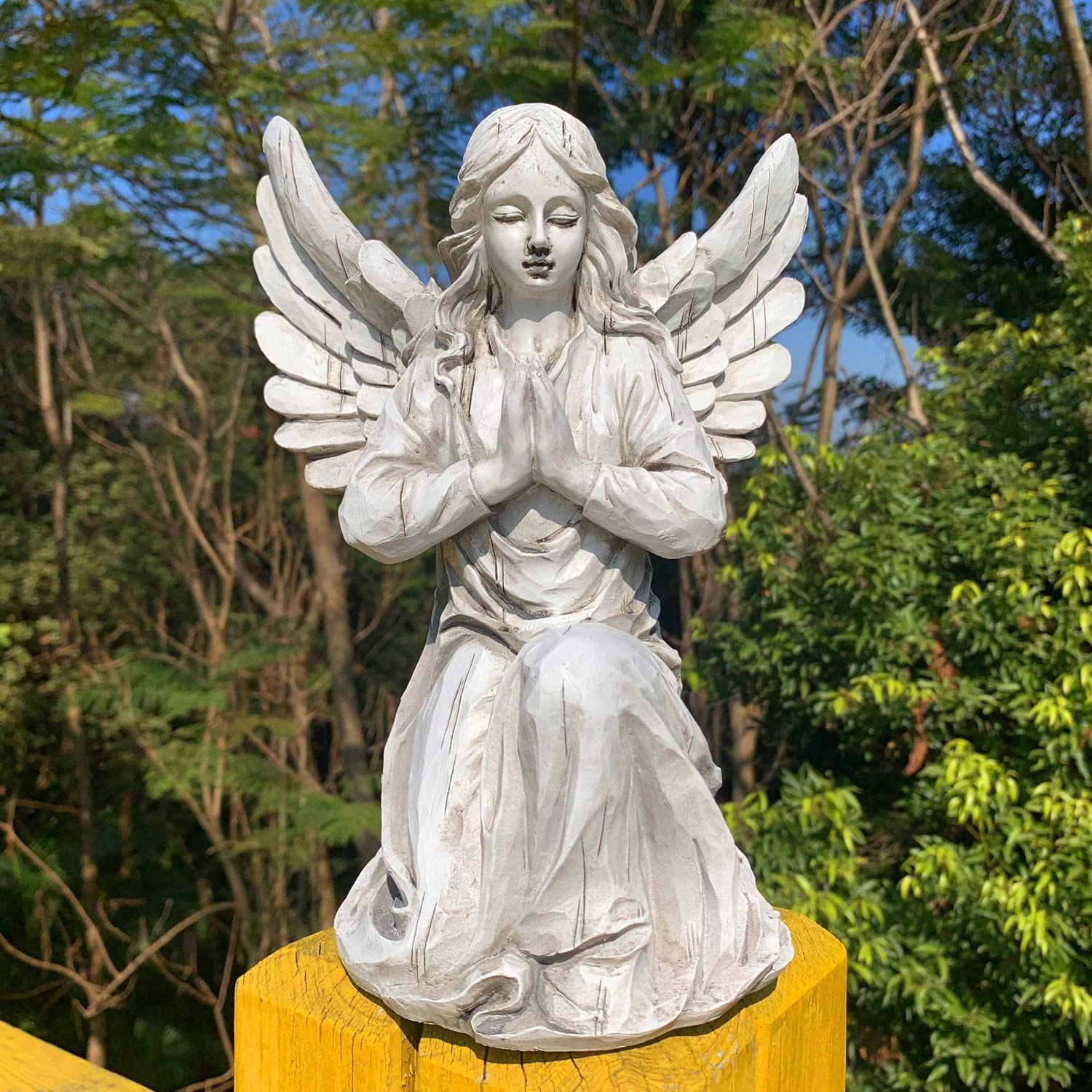 Handsider entryway angel statue creates a welcoming, peaceful entrance.