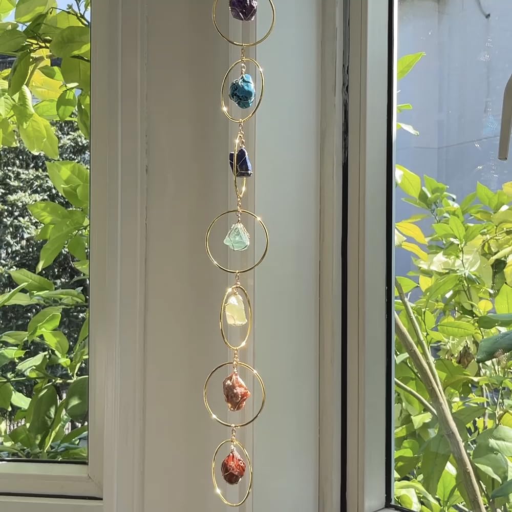 Green crystal wind chime from HausArtX complements greenery and promotes balanced ambiance.