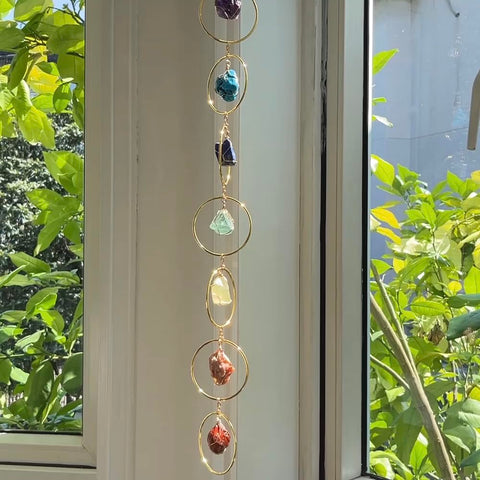 Green crystal wind chime from HausArtX complements greenery and promotes balanced ambiance.