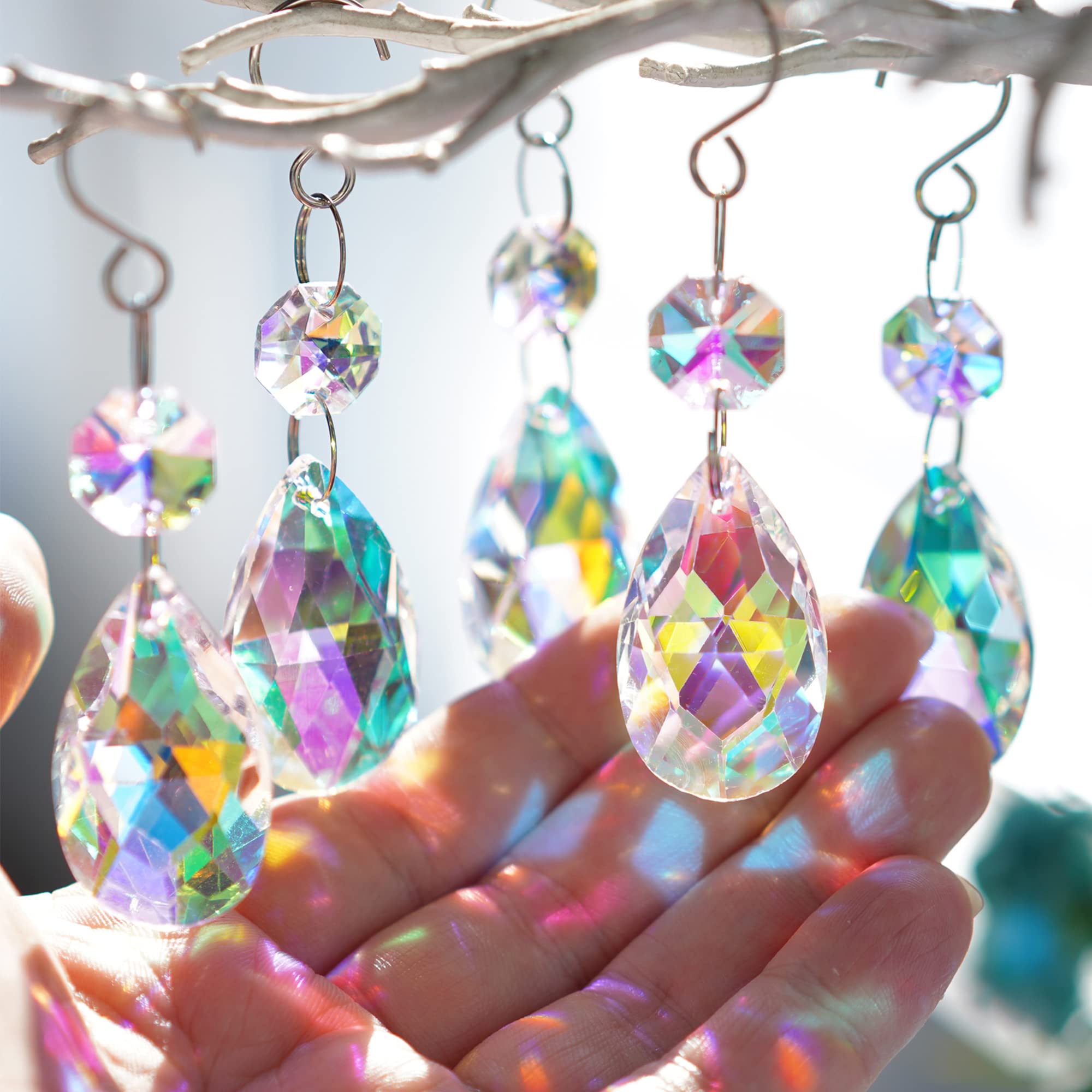 H&D HYALINE & DORA teardrop crystal 38mm pendant sparkles in sunlight, creating colorful reflections.