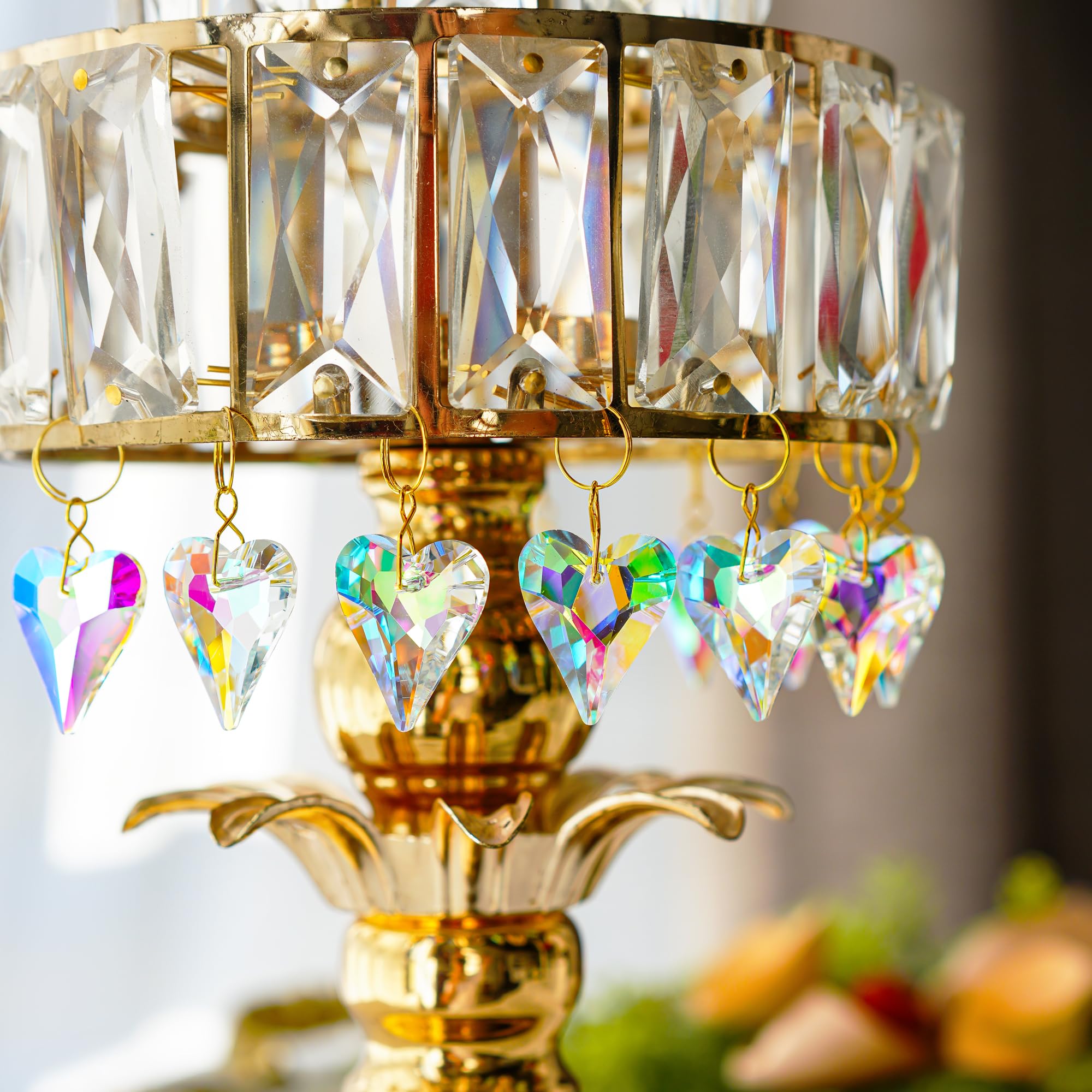 HD Hyaline Dora crystal heart prism hanging near blooms in the garden gate refracts sunshine into glittering specks.
