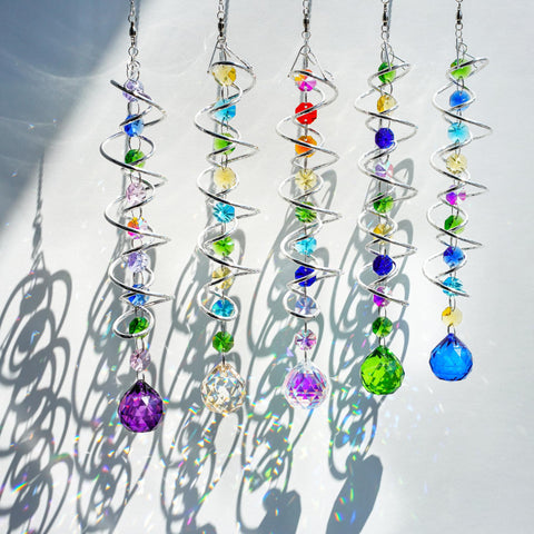 H&D Hyaline & Dora spiral tail wind spinner showcases rainbow prisms outdoors.