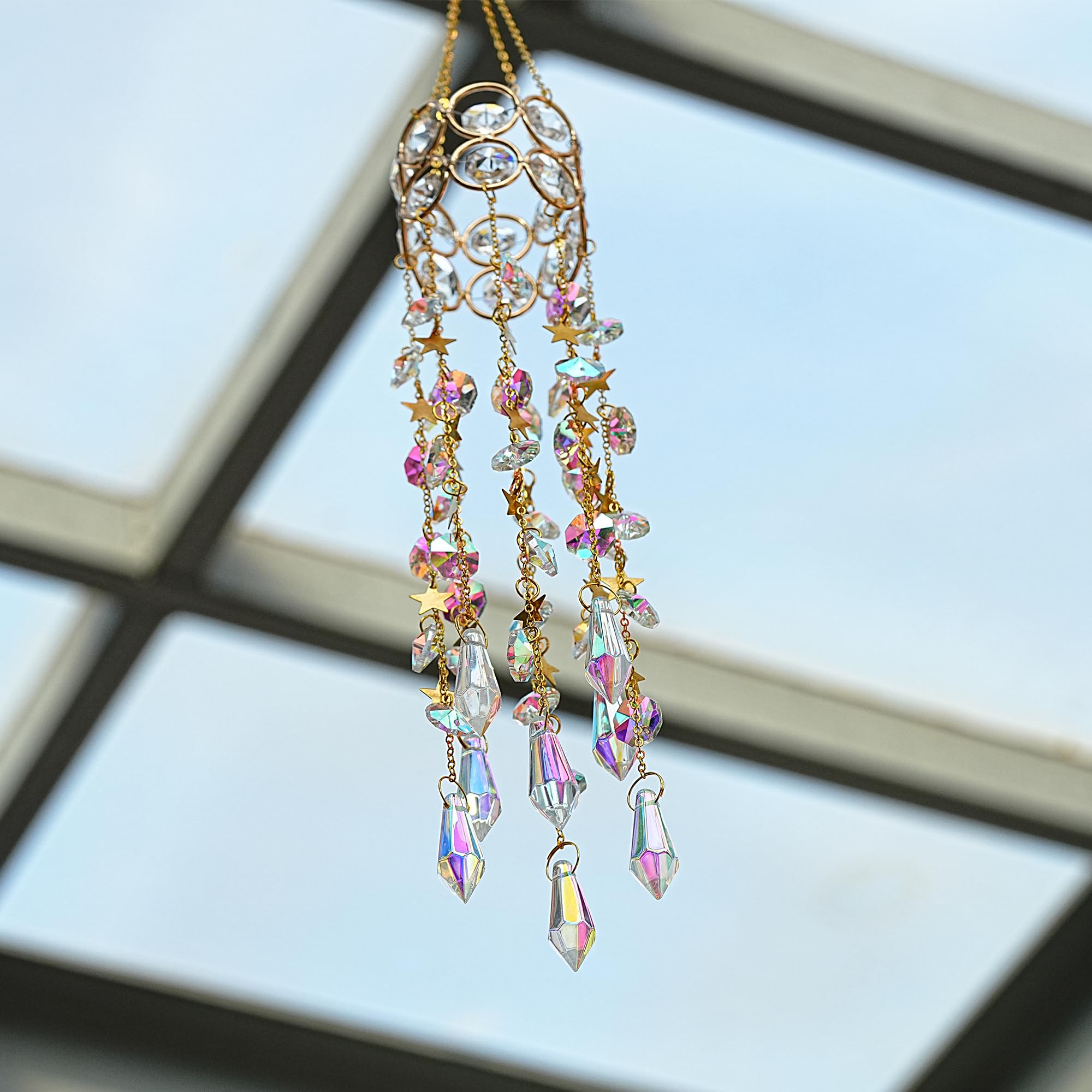 Hanging the crystal suncatcher from a window with its built-in hook