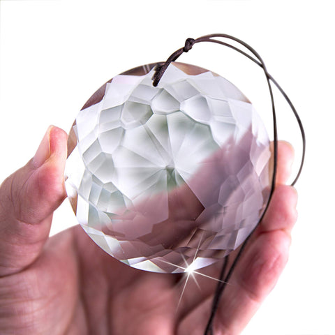 HDCRYSTALGIFTS 75mm prism suncatcher catching sunlight to cast rainbow glow in windows