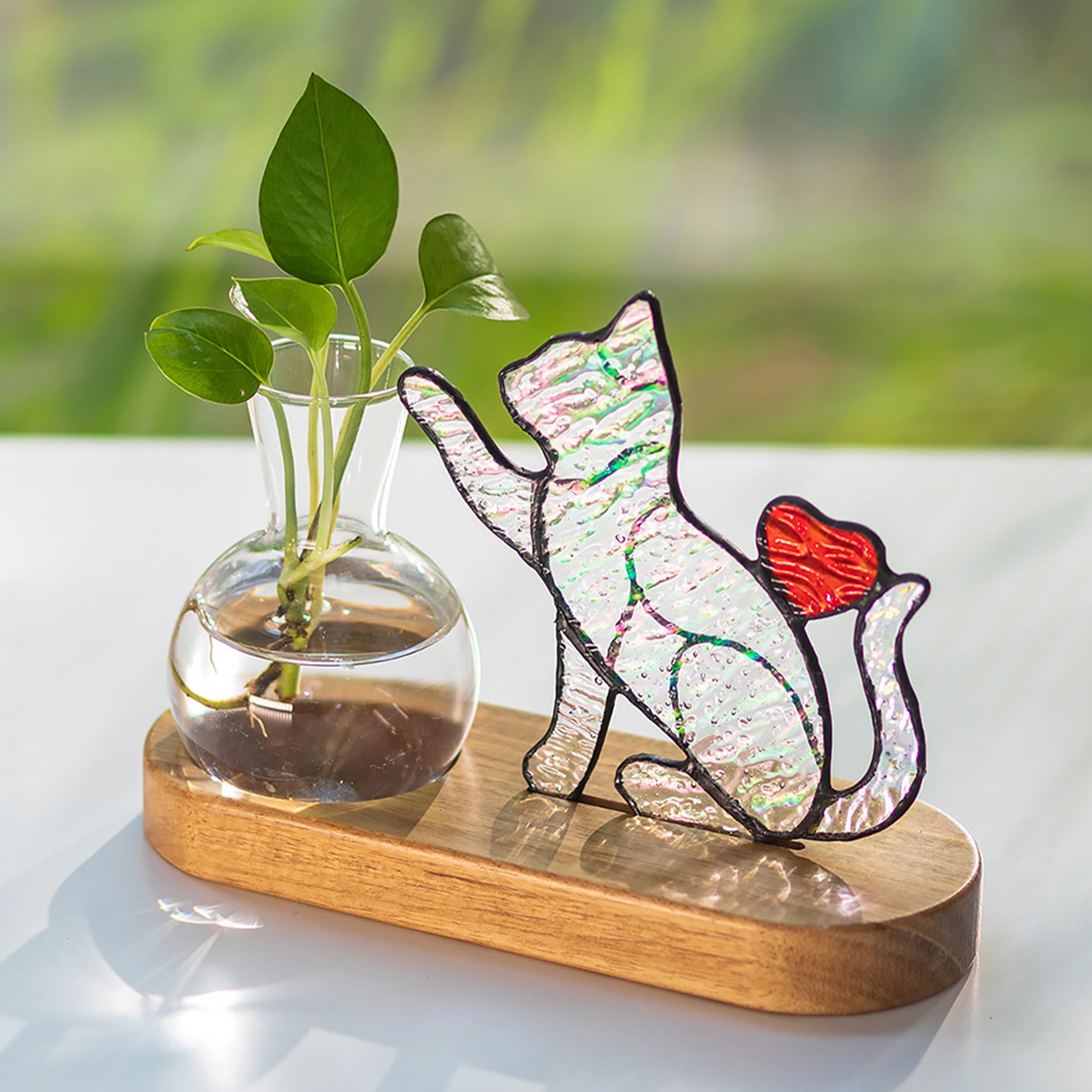 Hewory iridescent cat stained glass planter on desk, colorful light reflections.