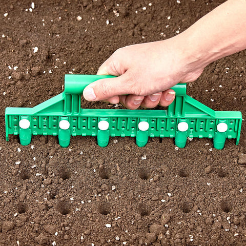 HHTHH Seed Dibber with green handle and pins for precise seed spacing.