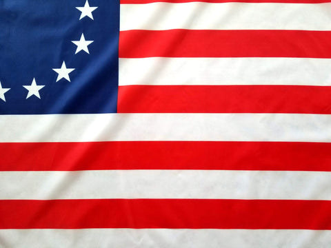 Betsy Ross flag with brass grommets for secure mounting on flagpoles.