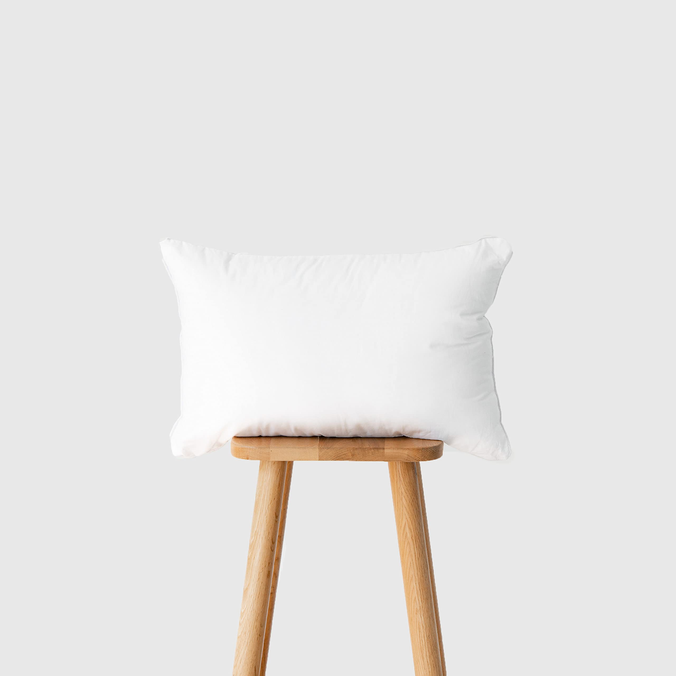 Hofdeco Premium lumbar pillow insert on outdoor chair delivering supportive comfort outdoors.