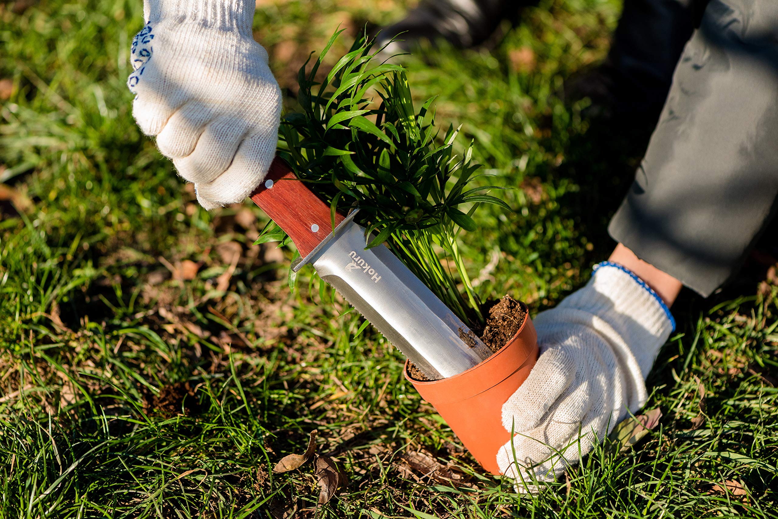 HOKURU Hori Hori knife cutting and pruning for versatile garden use.