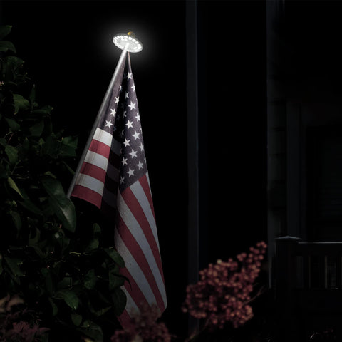Dusk-to-dawn illumination from HOOPLE flag light enhances flag visibility.