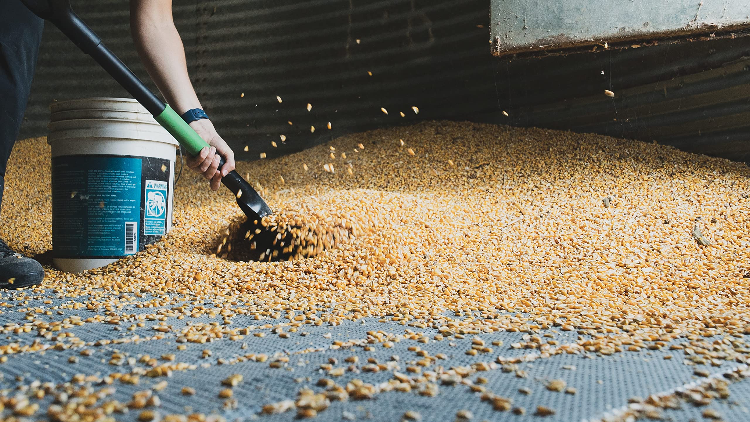 Hooyman scoop shovel in garden use demonstrates versatile material handling