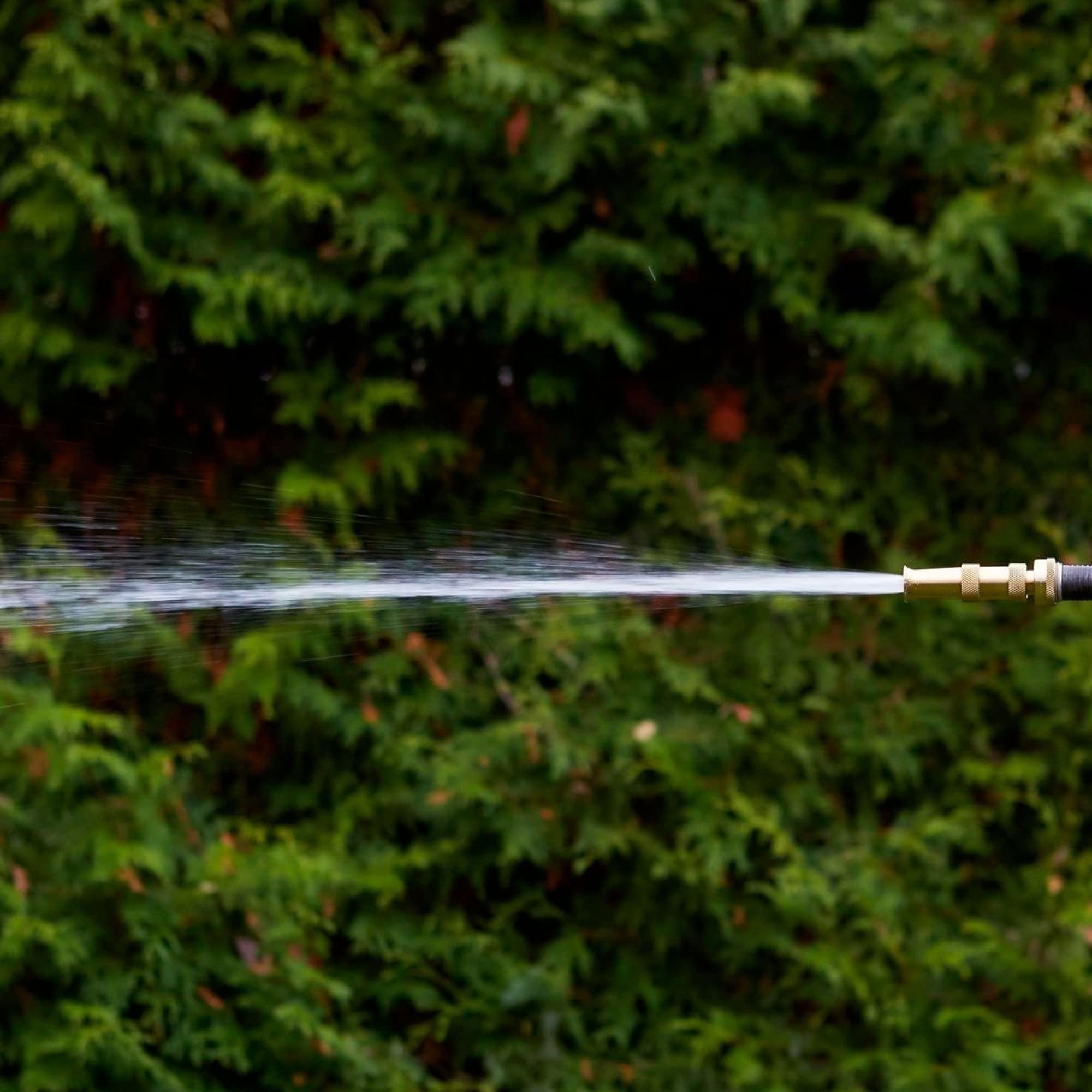 Hourleey durable hose nozzle in action resisting outdoor wear.