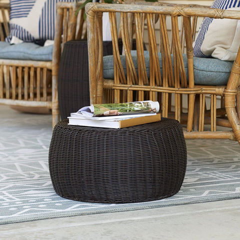 Household Essentials storage stool used as a footrest in a cozy living area.