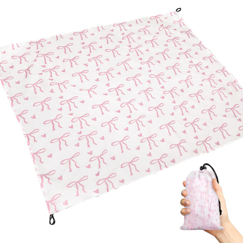 HunnmingRe Pink Bow Pocket Blanket in its storage bag attached to a backpack