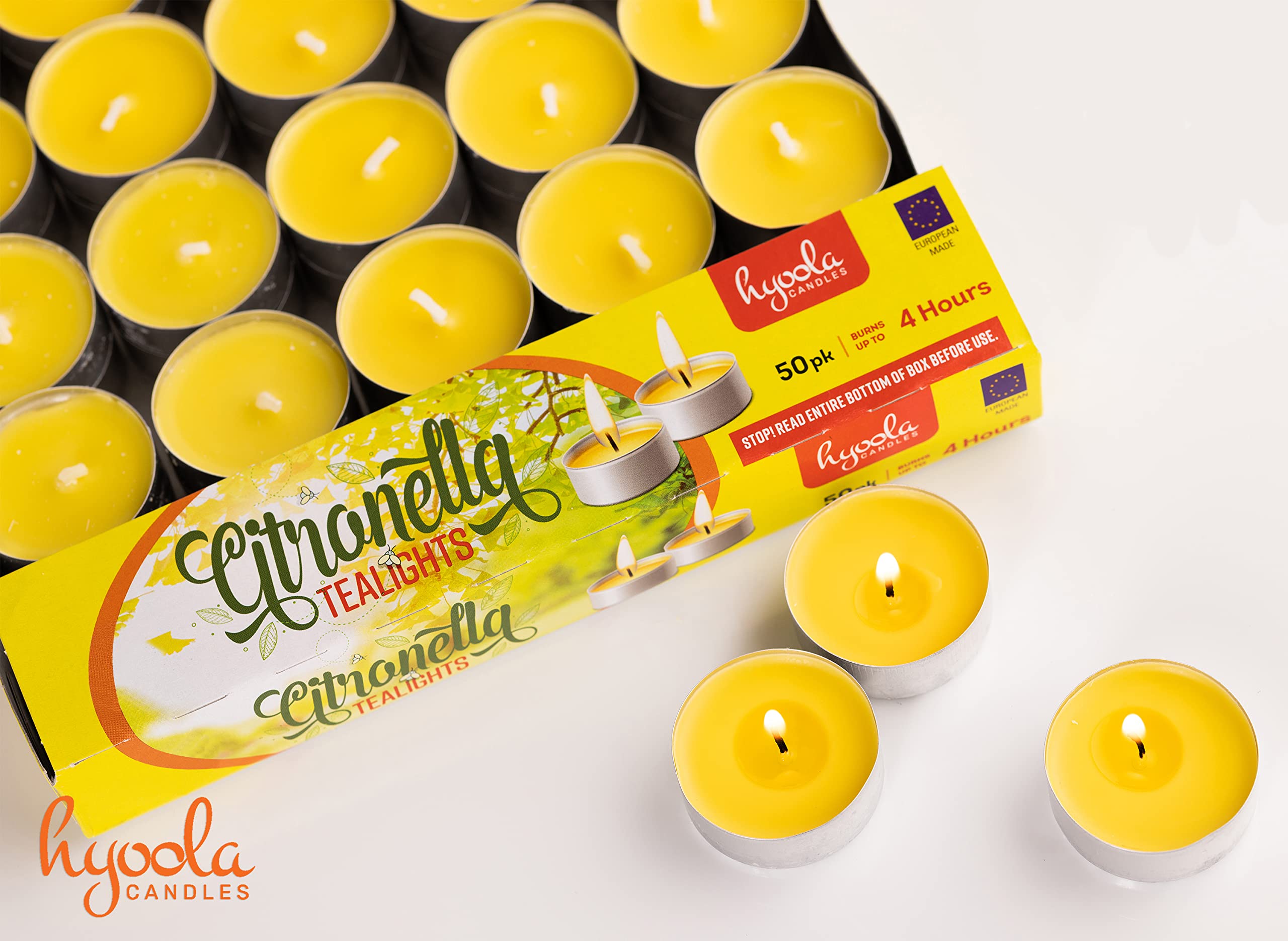 Hyoola citronella tealight glowing beside seating outdoors for ambience.