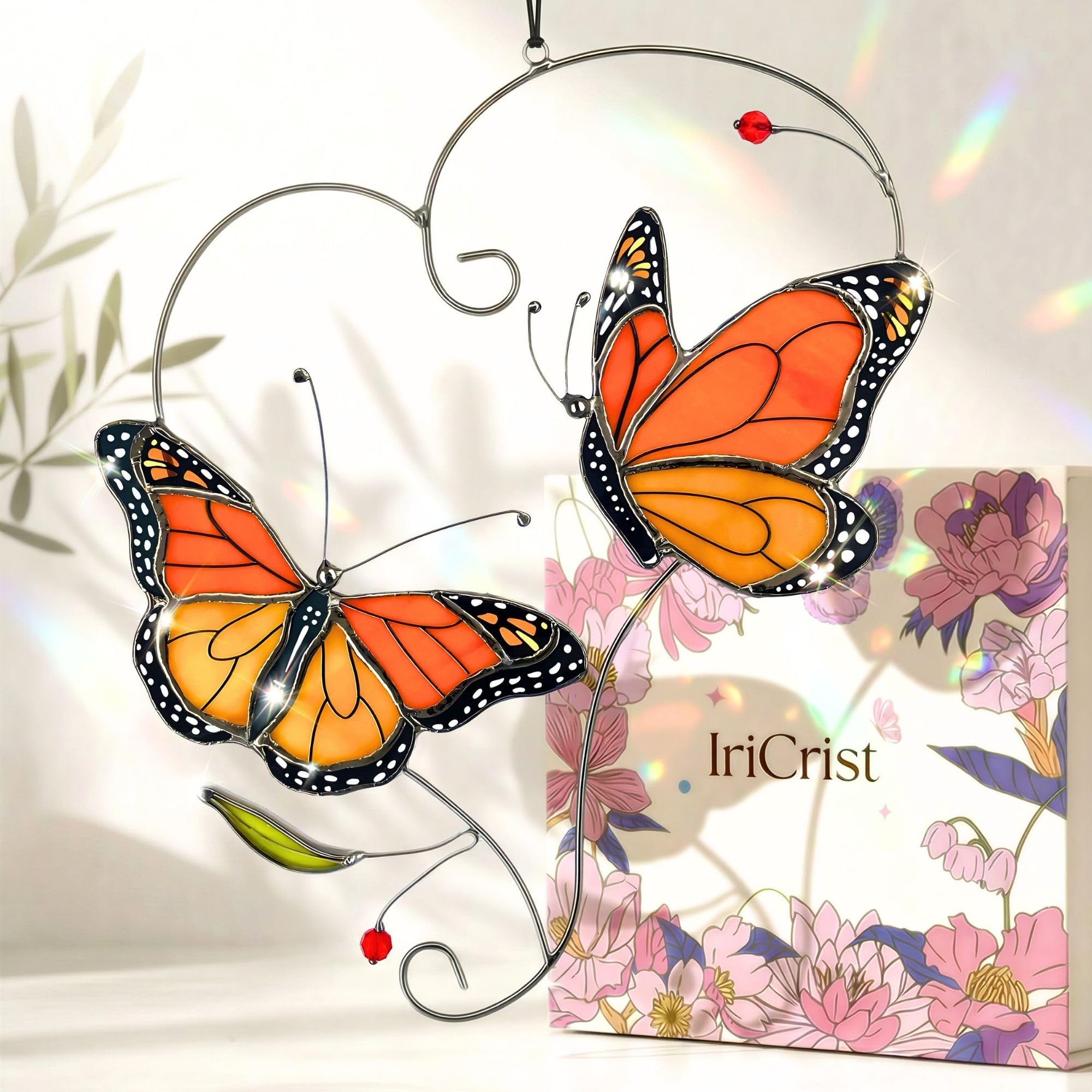 IriCrist Monarch butterfly suncatcher on a branch brightens window display